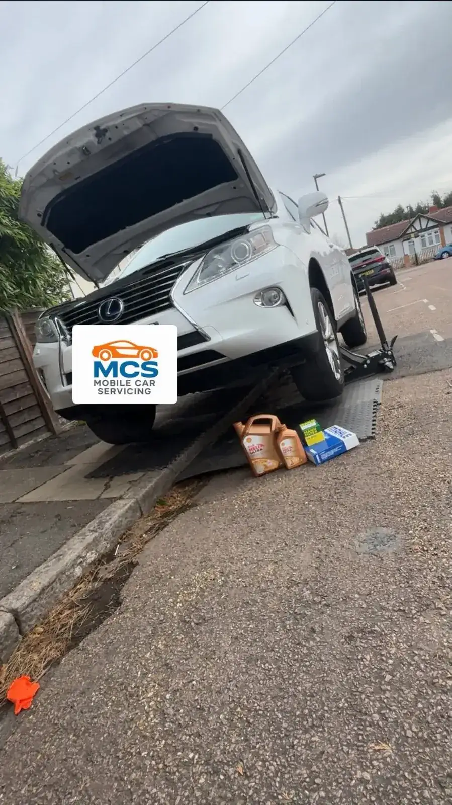Lexus raised on a ramp with fresh oil and filter ready for a mobile service