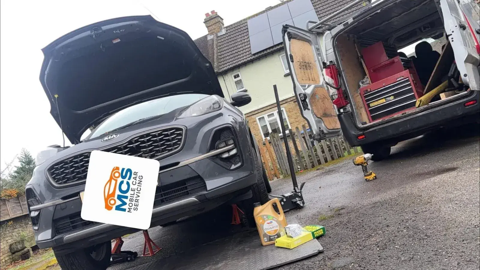 Car raised on axle stands on a driveway for a full mobile vehicle inspection