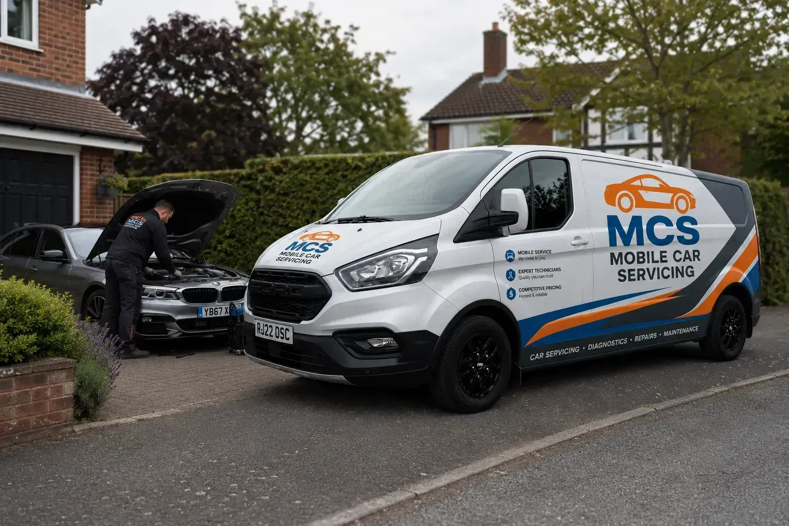 Liveried MCS Mobile Car Servicing van parked on a driveway, mechanic working on a car behind it