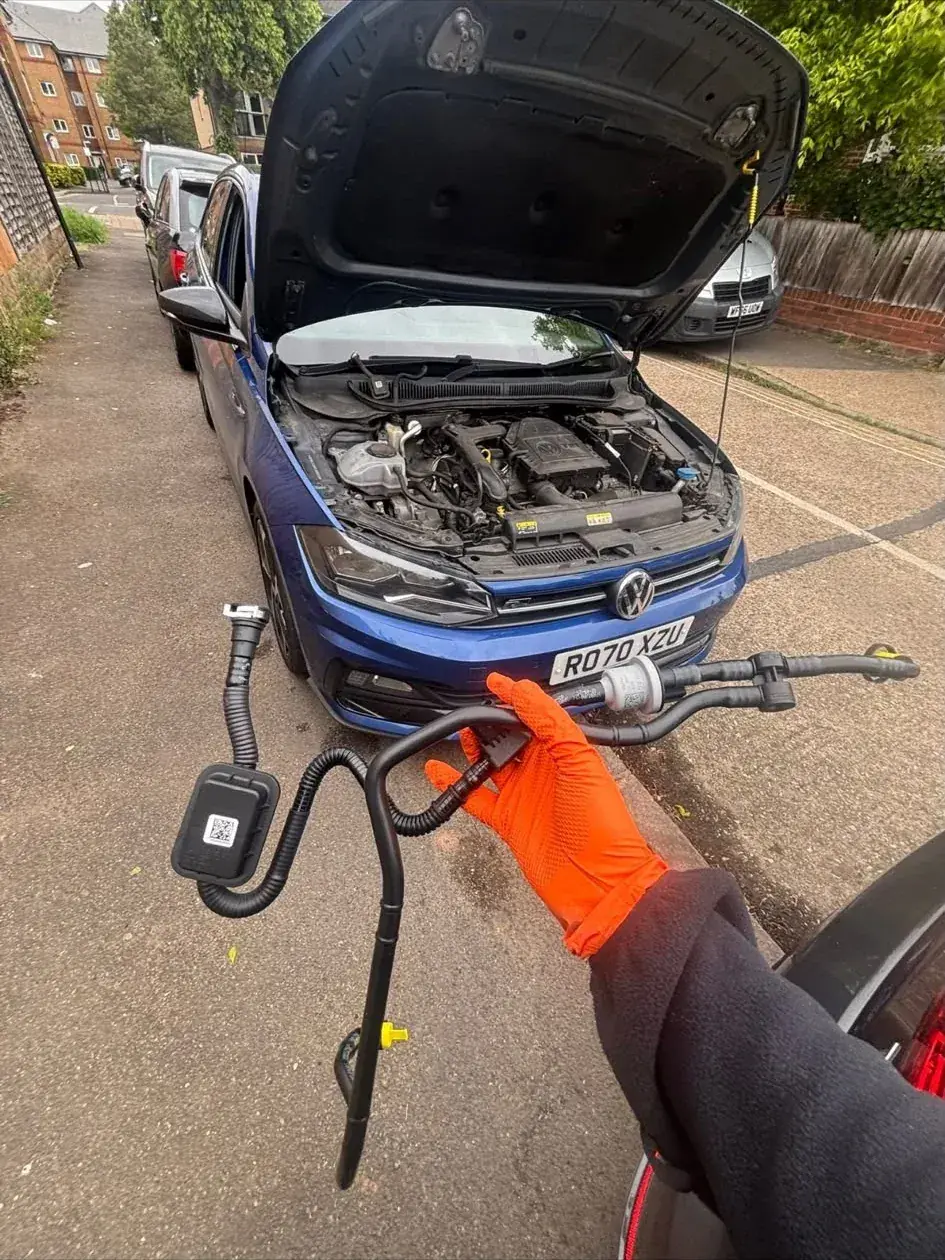 Diagnostic sensor connected to a Volkswagen's engine bay